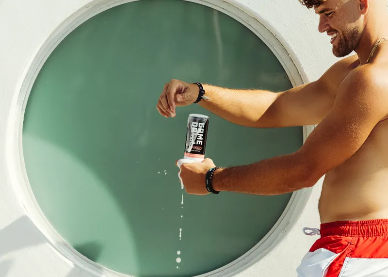 Cracking a GameDay Spiked can beside a pool