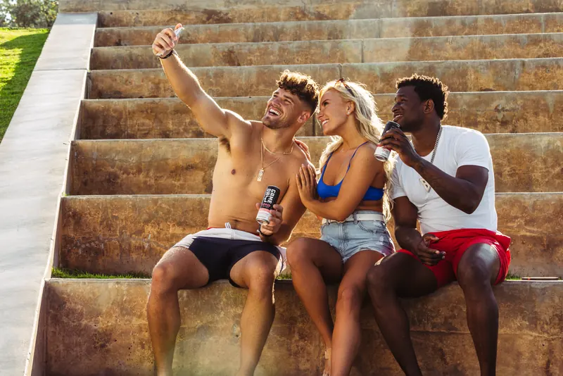 Two friends sitting on the steps with GameDay Spiked